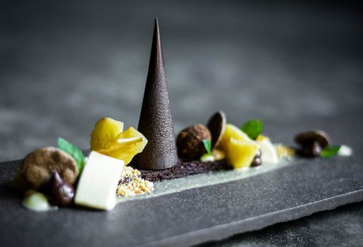 gourmet modern deconstructed chocolate cake and dried fruit dessert dish