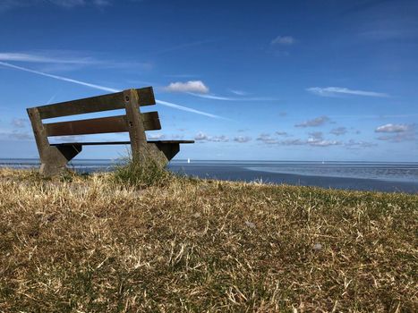 Bench on a dike at the wadden sea 