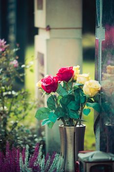 Remembrance concept: Bouquet of roses on a grave