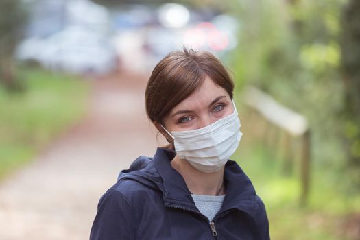 Flue and corona safety concept. Woman wearing face mask to protect herself, outdoors