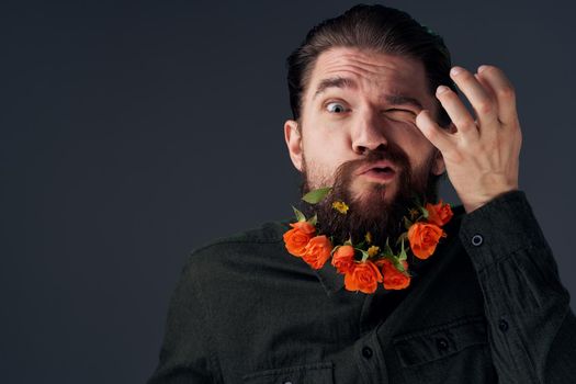 Bearded man with flowers decoration romance attractive look close-up