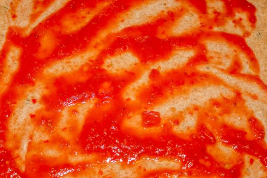 Homemage pizza dough with tomatoe sauce and no topping.