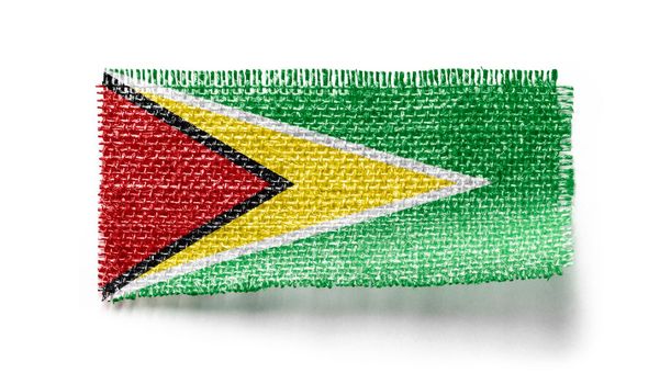 Guyana flag on a piece of cloth on a white background