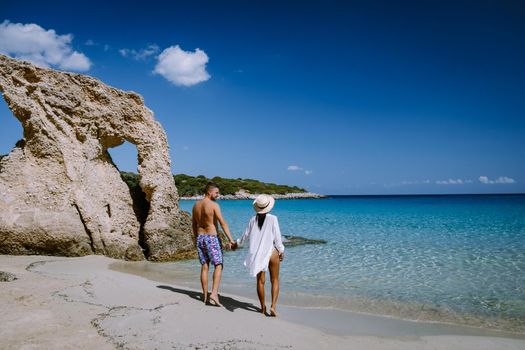 Young happy couple on seashore Crete Greece, men and woman Voulisma beach crete Greece