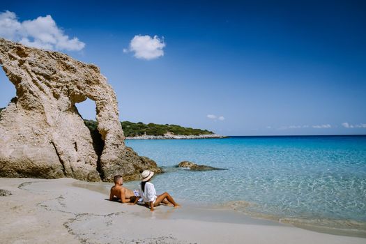 Young happy couple on seashore Crete Greece, men and woman Voulisma beach crete Greece