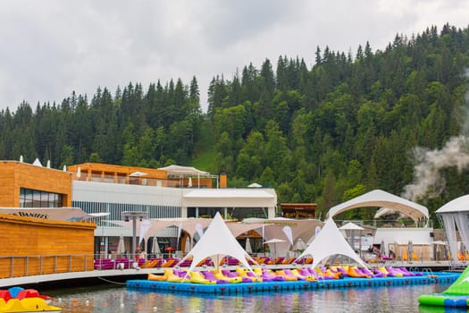 Entertaiment of Voda club on the pond among Carpathian mountains. Rental boats for lake tour