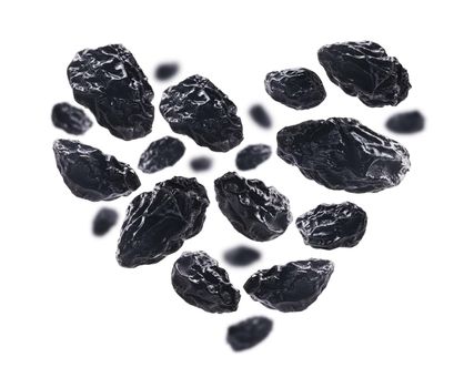 Dried plums in the shape of a heart on a white background