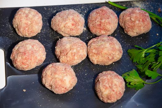 Cooking meat cutlets. Semi-finished meatballs on a cutting board.