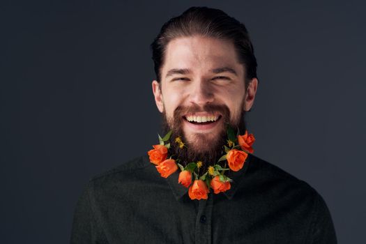 Portrait of a bearded man flowers romance decoration gift dark background. High quality photo