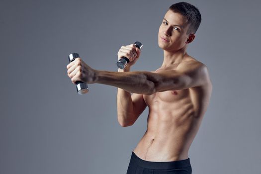 sporty man inflated torso dumbbells in hand workout fitness