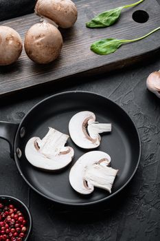 Royal champignons, Parisian champignons in cast iron frying pan, on black background