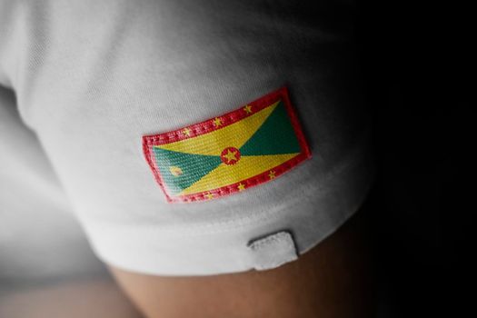 Patch of the national flag of the Grenada on a white t-shirt