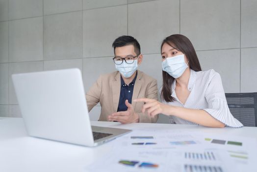 Business employees wearing mask during work in office to keep hygiene follow company policy