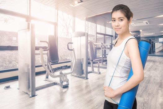 Asian healthy woman ready to exercising at sport gym, girl doing sport indoor.Photo design for fitness sporty woman and health care concept.