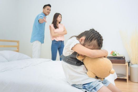 Asian little girl sadness while parent quarrelling in bedroom