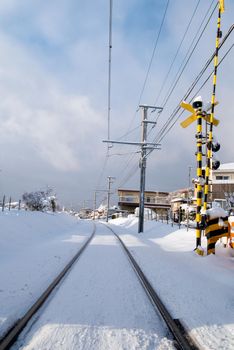 Railway track for local train with white snow fall in winter season,Japan