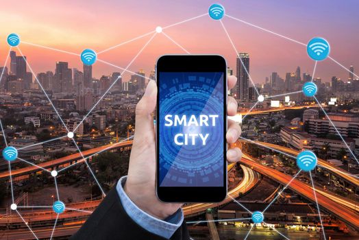 Young Smart business woman is using smart technology of internet of things in smart city for global business connection. Photo design for smart city and smart technology internet of things concept