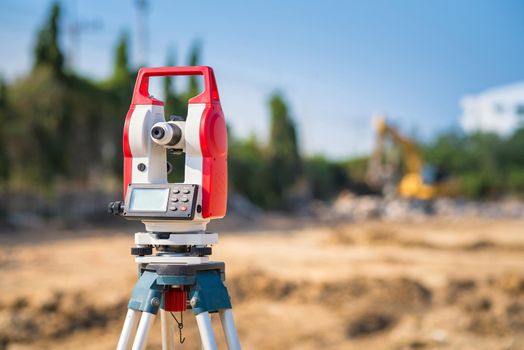 Surveyor equipment tacheometer or theodolite outdoors at construction site for civil engineer checking the construction area 