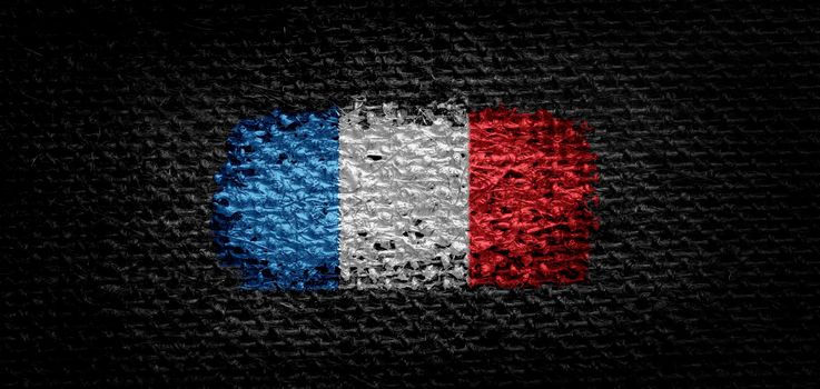National flag of the France on dark fabric
