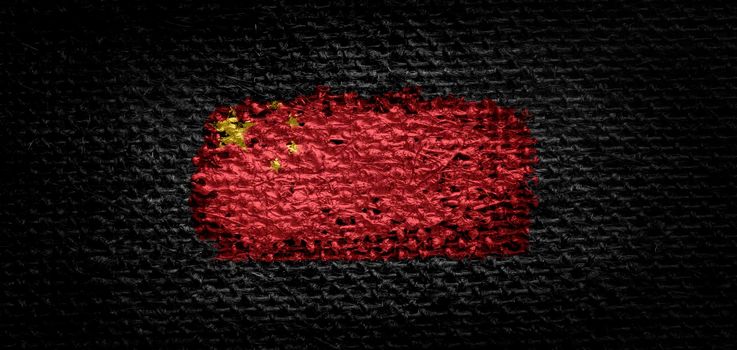 National flag of the China on dark fabric