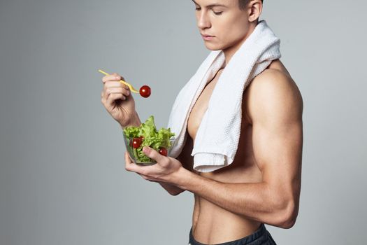 sporty man with towel on shoulders on healthy food vegetarianism isolated background