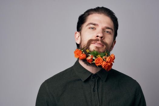 Elegant man black shirt flowers in a beard decoration romance attractive look. High quality photo