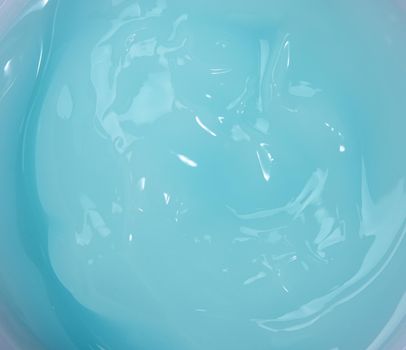 blue moisturizing translucent cream in a plastic jar