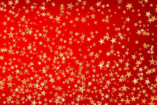 Stars golden glitter confetti isolated on blurred abstract red background. Festive holiday background. Celebration concept. Falling magic gold particles. Invitation mock up. Top view, flat lay.