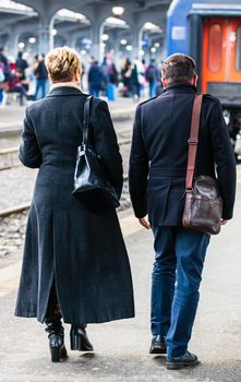 Couple on their way to the train platform at Bucharest North Railway Station (Gara de Nord Bucharest) in Bucharest, Romania, 2020