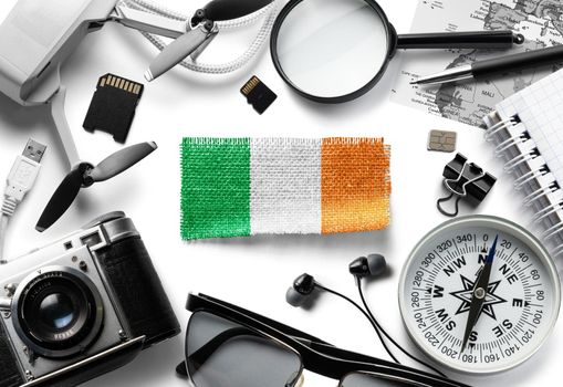 Flag of Ireland and travel accessories on a white background.