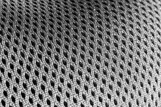 Macro shot of a mesh-like undulating gray silver surface