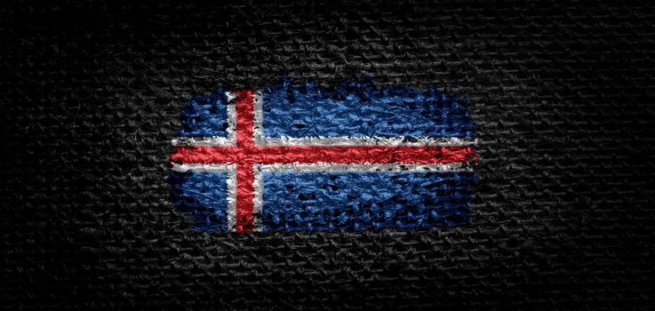 National flag of the Iceland on dark fabric