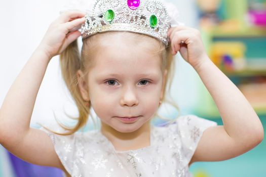 Belarus, the city of Gomil, December 27, 2018. Morning party in kindergarten.The face of the child in the crown. Three year old queen girl.