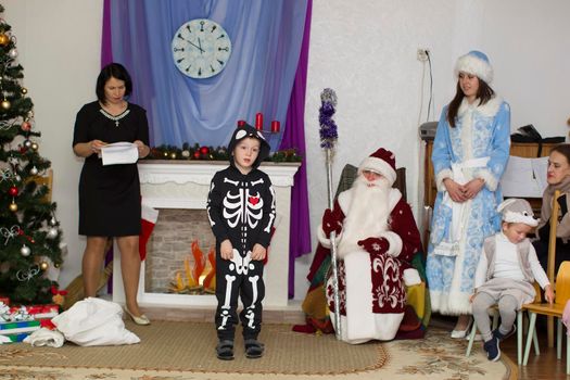 Belarus, the city of Gomil, December 27, 2018. Morning party in kindergarten.A boy in a skeleton costume reads poetry at a holiday in kindergarten.
