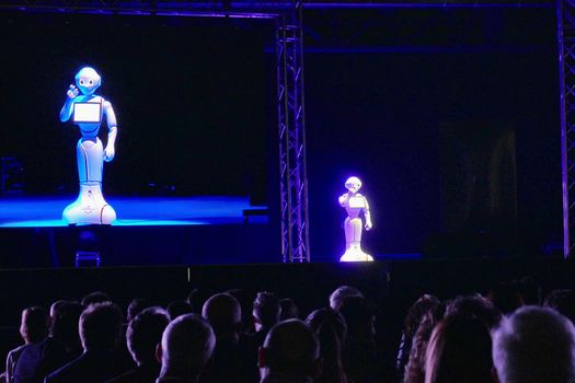 Pepper humanoid robot interact with audience at economics conference