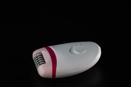 Hair removal concept, electric razor isolated on black background.