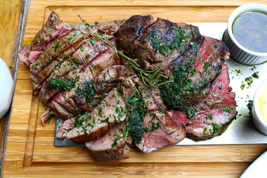 Portion of grilled beef chateaubriand with herbs