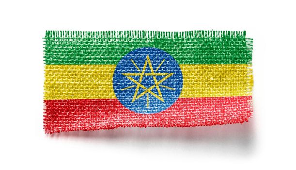 Ethiopia flag on a piece of cloth on a white background