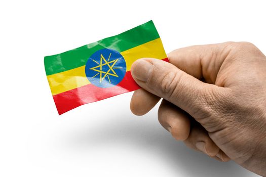 Hand holding a card with a national flag the Ethiopia