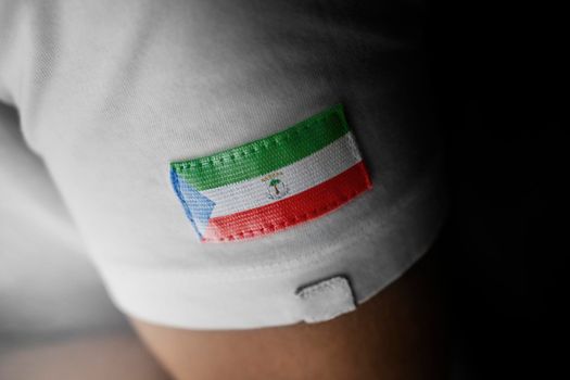 Patch of the national flag of the Equatorial Guinea on a white t-shirt