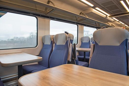 Interior of an empty commuter train carriage with seats