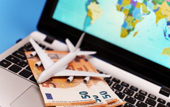 Toy plane on the notebook with world map.
