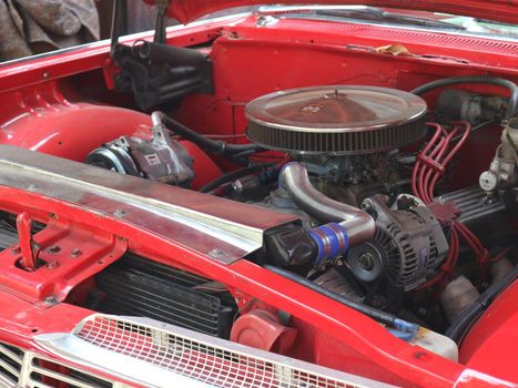 modified engine in classic antique red Chevrolet car 1959 era on show