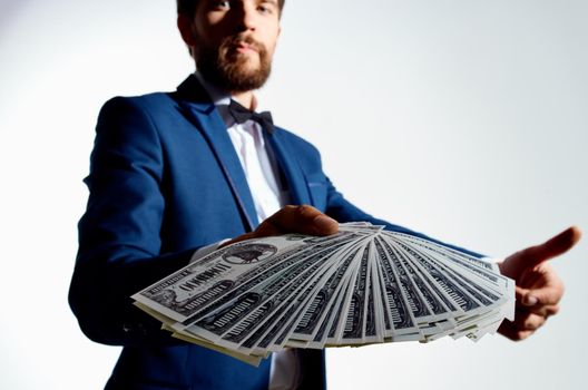 rich guy with a stack of bills money classic suit gesturing with his hands