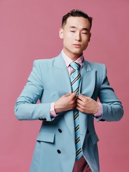 Business man blue jacket self confidence pink background