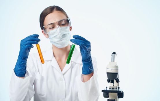 woman biologist in medical gloves vaccination microscope on research table in chemical element. High quality photo