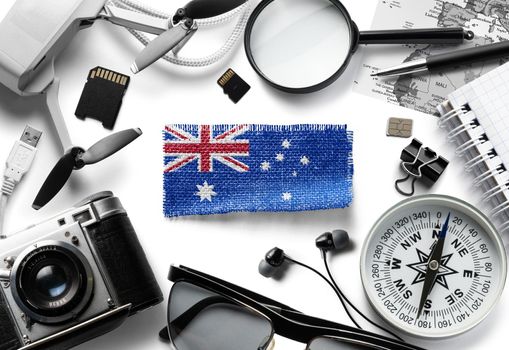 Flag of Australia and travel accessories on a white background.