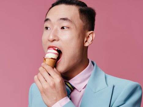 cute Man eating ice cream cropped view emotion pink enjoyment background