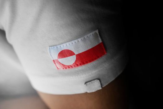 Patch of the national flag of the Greenland on a white t-shirt