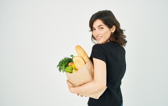 Woman with package of healthy diet food household shopping in store